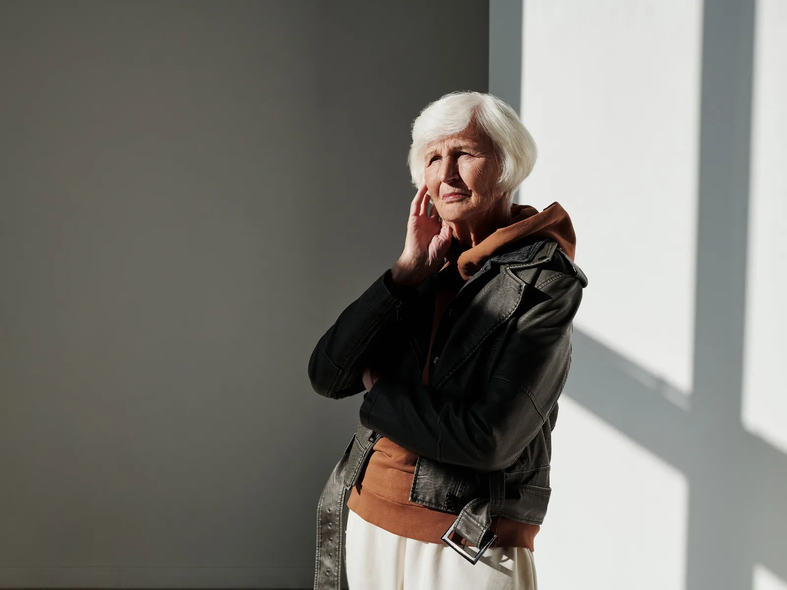 A woman in her sixties smiling in warm natural light